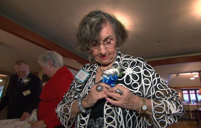 Marilyn Unger pins on her corsage at the Hillhouse High School class of 1943 reunion and prom.