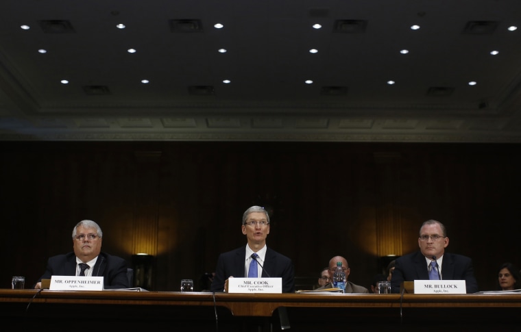 Apple CEO Tim Cook (C), CFO Peter Oppenheimer (L) and Apple Head of tax operations Philip Bullock appear before a Senate homeland security and governm...