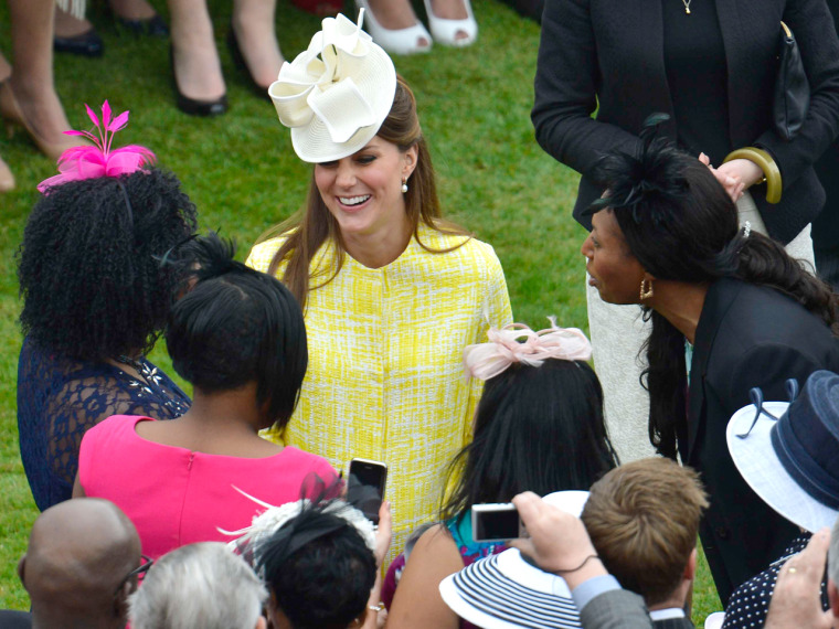 Duchess Kate talks to guests as she attends a Garden Party in the grounds of Buckingham Palace hosted by Queen Elizabeth II on May 22, 2013.