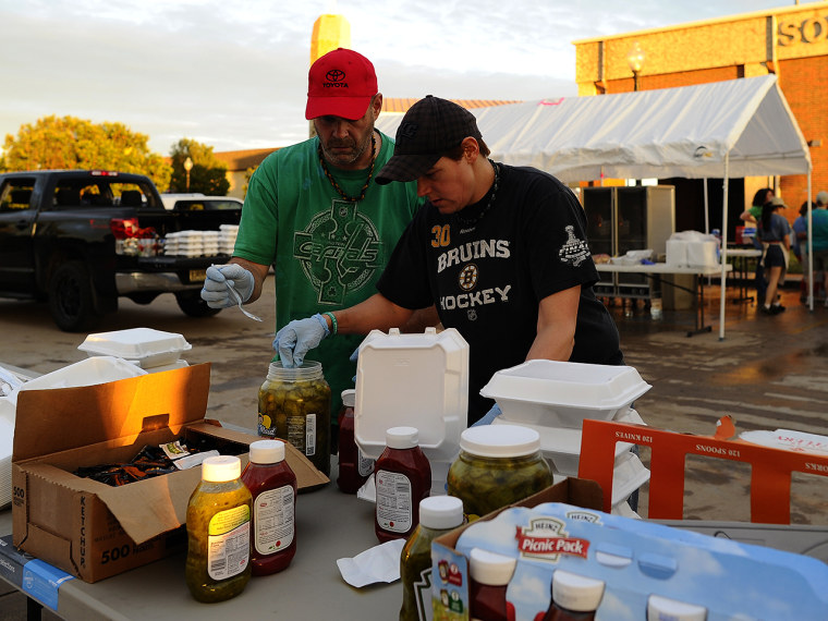 Volunteers from Mercy Chefs prepare food for tornado victims on May 21, 2013 in Moore, Oklahoma. Families returned to a blasted moonscape that had bee...