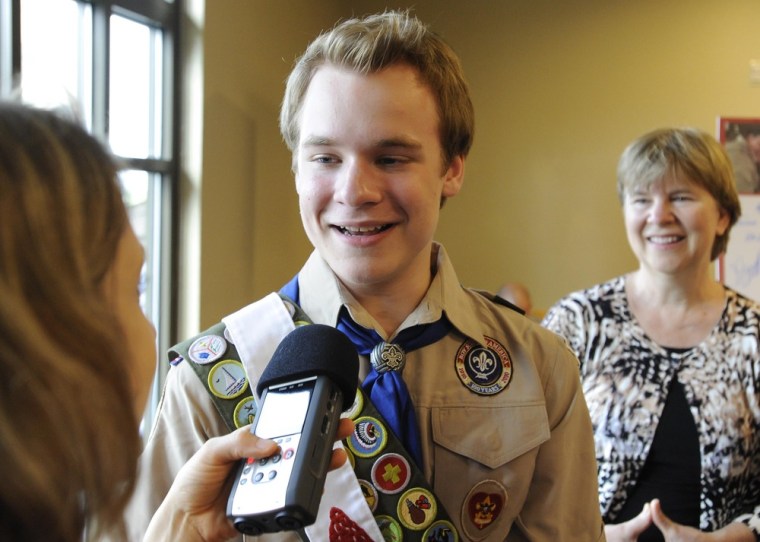 Pascal Tessier, 16, from Kensington, Md., an openly gay scout who was facing expulsion from the Boy Scouts, answers questions from the media while his mother, Tracie Felker, looks on.