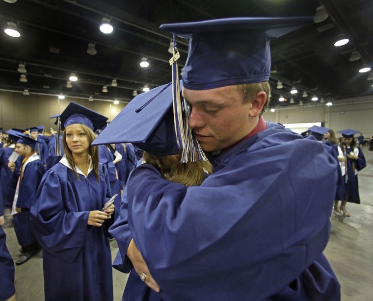 Southmoore High School senior Jake Spradling, hugs a classmate as they get ready to attend their commencement ceremony in Oklahoma City on Saturday, five days after a tornado destroyed a large swath of Moore, Okla. Spradling's home was among those destroyed by the twister.