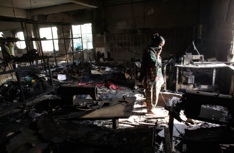 A worker visits the burned-out Tazreen Fashions factory in Bangladesh, where 112 people died in November.