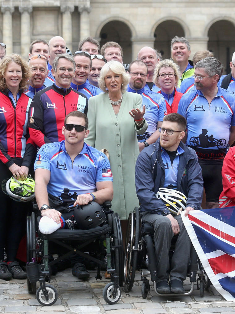 Camilla, Duchess of Cornwall poses with Help For Heroes fundraisers taking part in the Big Battlefield Bikeride at Les Invali...