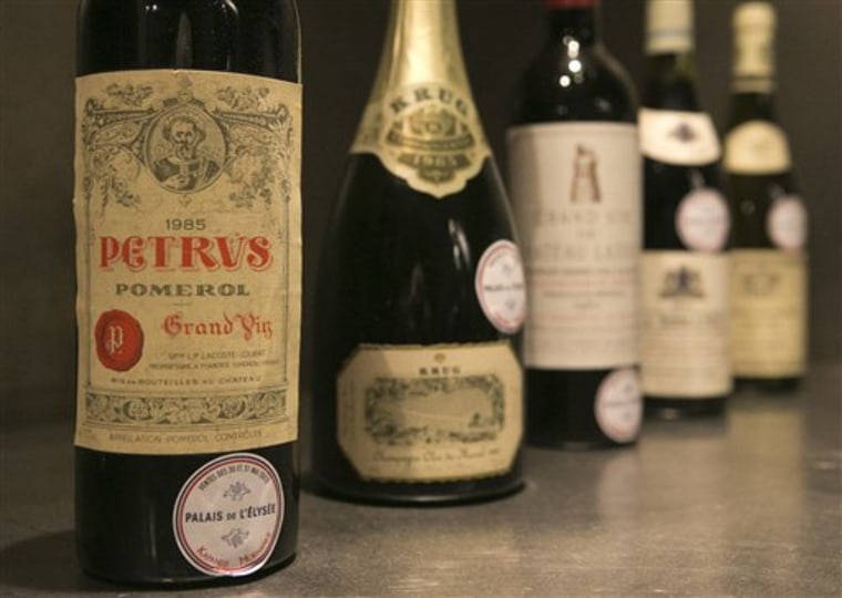 In this photo dated Tuesday May 28, 2013, a bottle of Chateau Petrus 1985 put on auction by the French presidential palace is displayed during an auct...