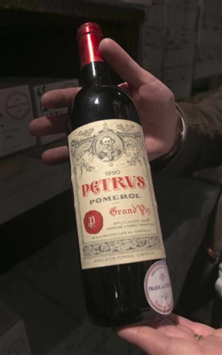 In this photo dated Tuesday May 28, 2013, a bottle of Chateau Petrus 1990 put on auction by the French presidential Palace is displayed during an auc...