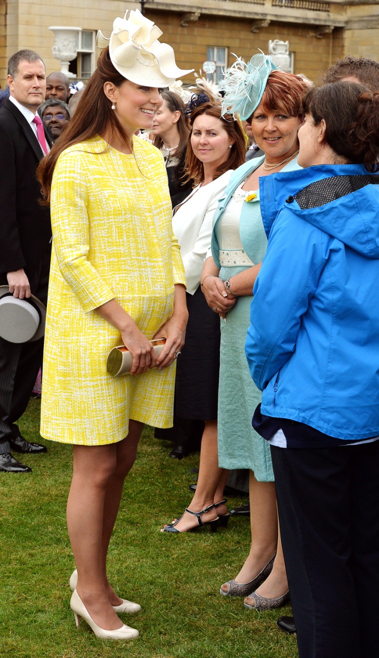 Pop of yellow: Duchess Kate talks to guests as she attends a garden party in the grounds of Buckingham Palace hosted by Queen Elizabeth II on May 22, 2013.
