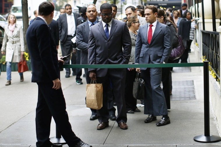 Job seekers stand in line to meet with prospective employers at a career fair in New York City, in this October 24, 2012 file photo.