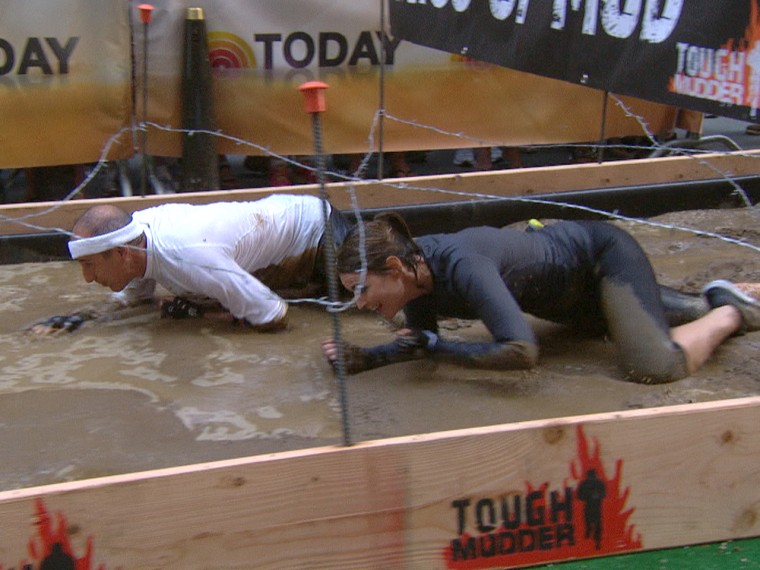It wouldn't be Tough Mudder without, you know, mud. Savannah and Matt ruin their outfits with this barbed wire obstacle.