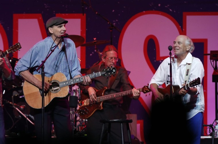 James Taylor, left, and Jimmy Buffett perform at the Boston Strong Concert.