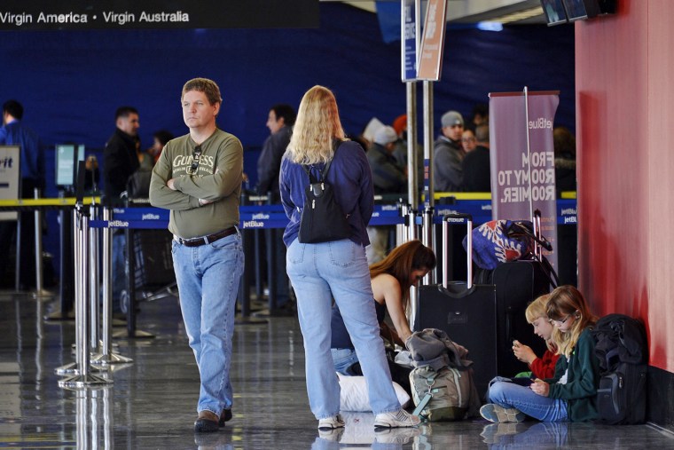LOS ANGELES, CA - NOVEMBER 2: A family waits to travel a day after a shooting that killed one Transportation Security Administration worker and injure...