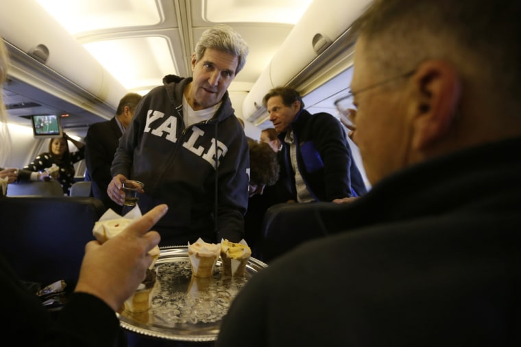 Secretary of State John Kerry offers cupcakes to members of the traveling press between Washington and the Middle East, Saturday.