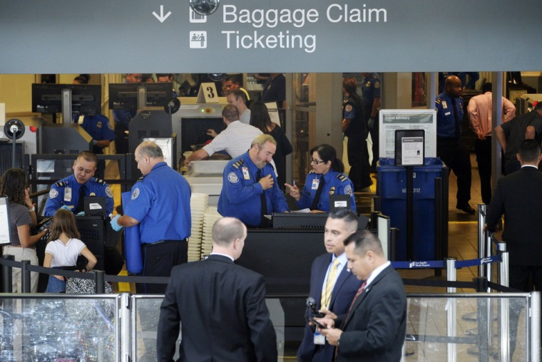 Travelers are screened byTransportation Security Administration agents after Terminal 3 was re-opened a day after a shooting at Los Angeles International Airport November 2.