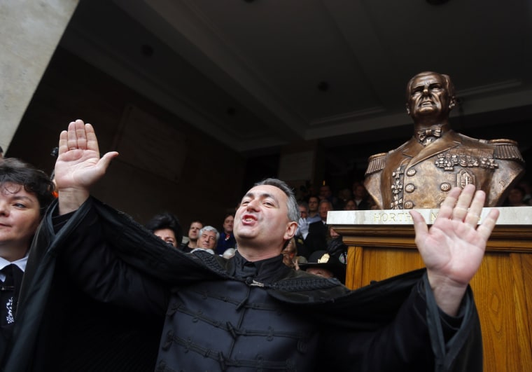 Hungarian pastor and far-right politician Lorand Hegedus unveils the statue of wartime leader Miklos Horthy in central Budapest November 3, 2013.