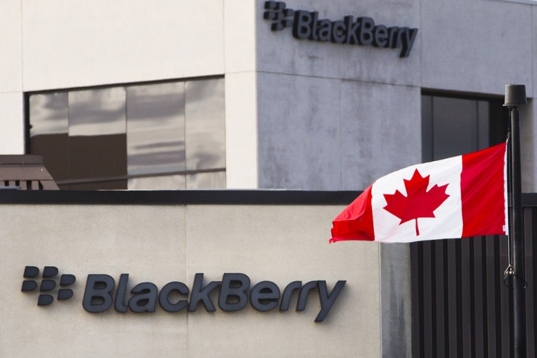 A Canadian flag waves in front of a Blackberry logo at the Blackberry campus in Waterloo, in this September 23, 2013 file photo.