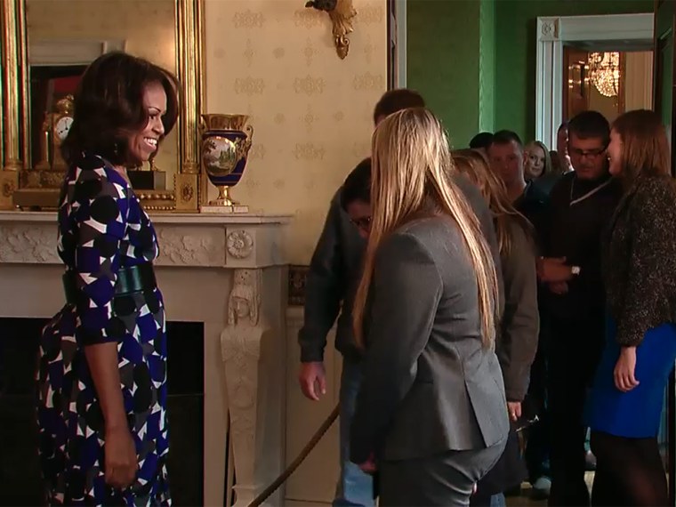 Mrs. Obama greeted unsuspecting guests Tuesday as White House tours resumed.