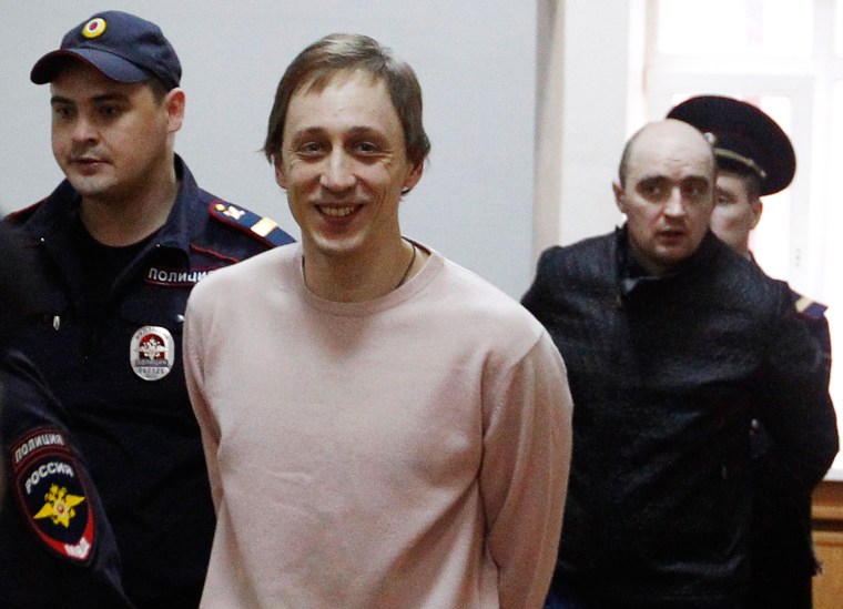 Bolshoi Theater dancer Pavel Dmitrichenko (second left), together with his co-defendants, is escorted before a court session in Moscow on Wednesday.