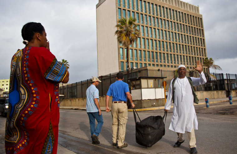 U.S. citizen William Potts, right, waves goodbye to his wife Aime Quesada, left, after he arrived to the U.S. Interests Section to be escorted to the airport by U.S. officials in Havana, Cuba, on Wednesday.
