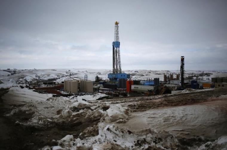 An oil derrick is seen at a fracking site for extracting oil outside of Williston, North Dakota on March 11, 2013.