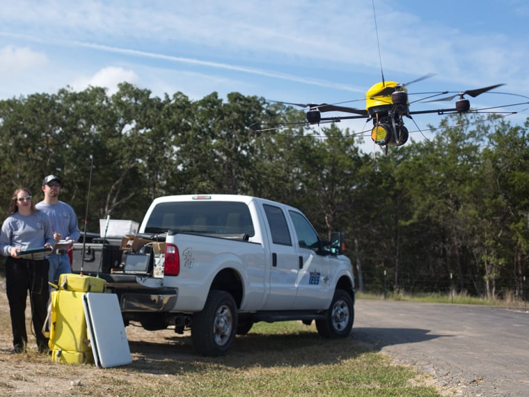 Doctoral candidate Brittany Duncan, center, flies an unmanned aerial vehicle at Disaster City in College Station, Texas on Friday, Sept. 28. On either...