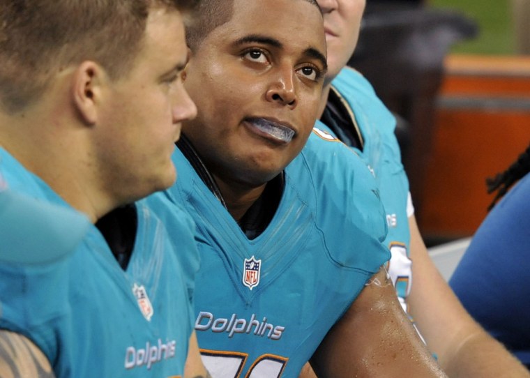 Miami Dolphins guard Richie Incognito, left, and tackle Jonathan Martin look up from the bench in the second half of an NFL football game against the New Orleans Saints in New Orleans, on Sept. 30, 2013.