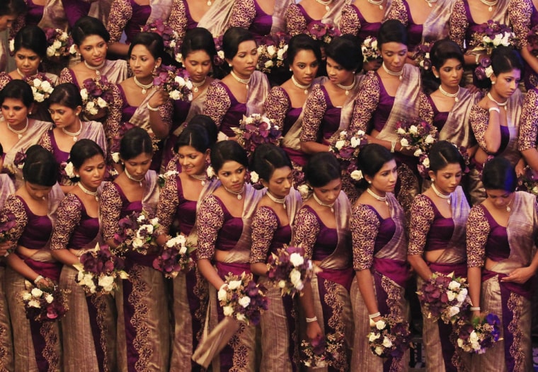 Bridesmaids pose for a photo during a record-breaking wedding ceremony in Negombo, Sri Lanka, on Nov. 8, 2013.