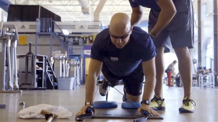 In this undated photo made from video and provided by Athletes Performance, U.S. Air Force, Chief Master Sgt. Damian Orslene works out in Gulf Breeze,...