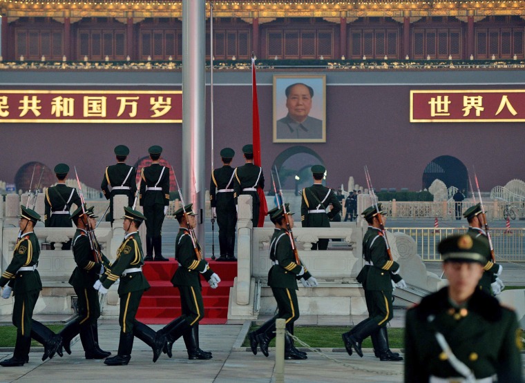 Chinese paramilitary police march during a flag-lowering ceremony in Tiananmen Square on Friday as security is increased on the eve of an important Communist Party Congress meeting in Beijing.