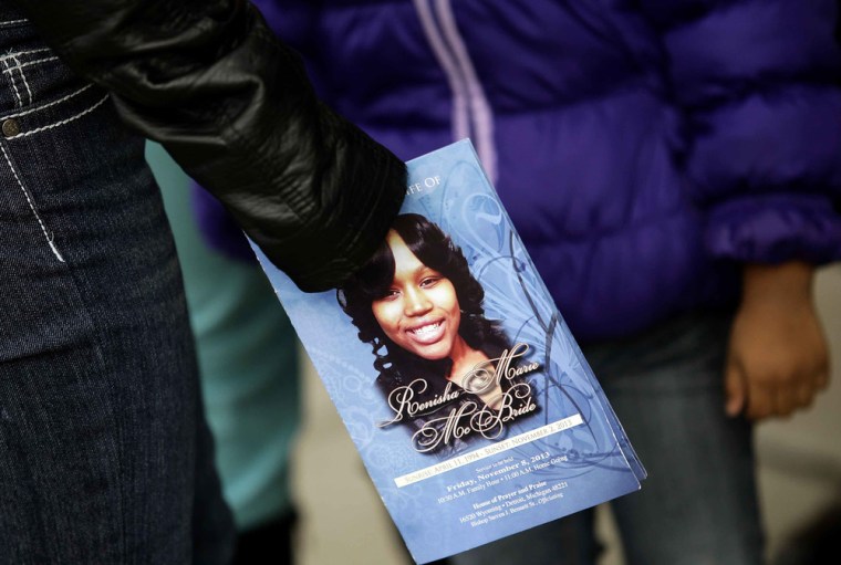 A mourner holds an obituary displaying a picture of Renisha McBride during her funeral service in Detroit, Michigan on Nov. 8, 2013. McBride was shot dead on Nov. 2 at a home in a suburb of Detroit. On Monday, her death was ruled a homicide.