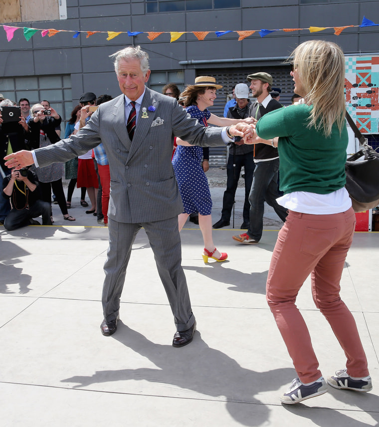 Prince Charles, Prince of Wales and Lisa Shannon (R)  dance at the Dance-O-Mat during a visit to Christchurc...