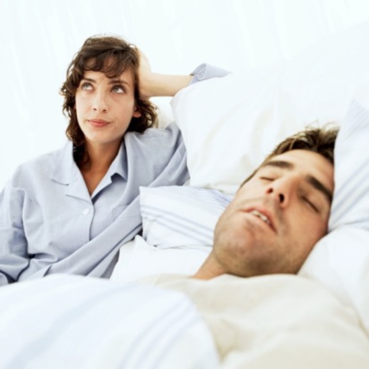 woman frustrated annoyed at man's snoring man bed pajamas sleep awake msnbc stock photography photo realtionship insomnia