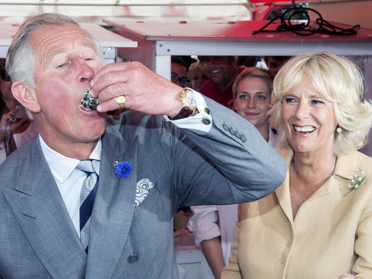 UNSPECIFIED, UNITED KINGDOM - JULY 29:  Camilla, Duchess of Cornwall watches as Prince Charles, Prince of Wales tries some Oysters during a visit to T...