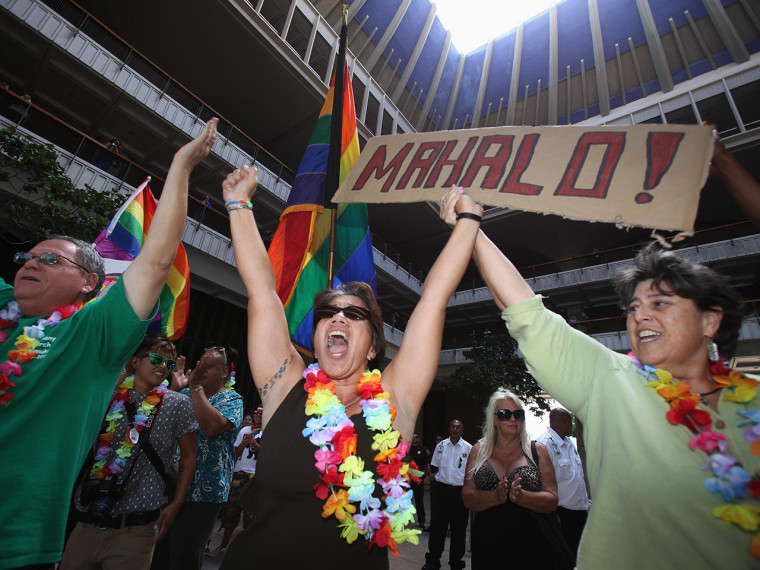 Tambry Young (center) and Debrah Zeleznik (right) celebrate after the Hawaii State Senate approved a bill allowing same-sex marriage in Hawaii on Tuesday.