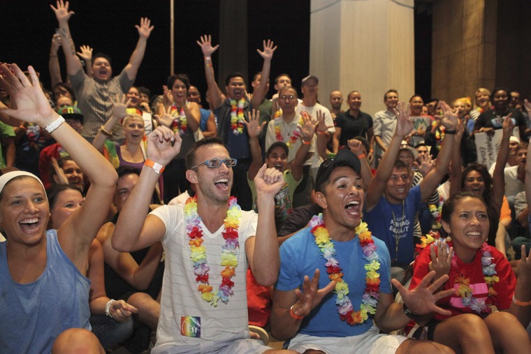 Jon Raffesberger (center, left) and his partner German Sanchez (center, right) celebrate after the Hawaii House of Representatives approved the same-sex marriage legislation on Nov. 8, 2013.