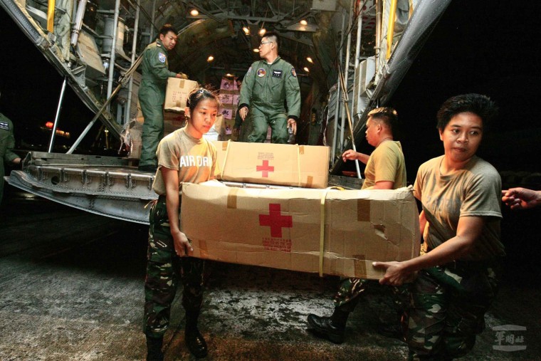 Filipino soldiers and volunteers unload relief goods from a Taiwan C-130 military cargo plane at the Cebu International Airport in the Philippines on Tuesday.