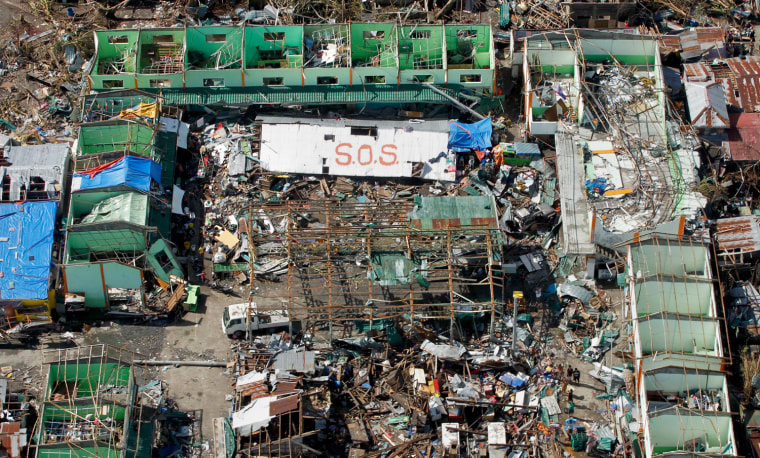 An SOS sign can be seen from the air amid the destruction left from Typhoon Haiyan in the coastal town of Tanawan, central Philippines, Nov. 13, 2013.