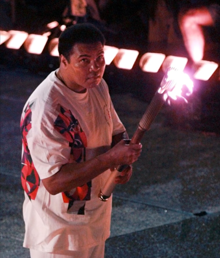 Ali, lighting the Olympic torch in 1996. He was diagnosed with Parkinson's disease in 1984.