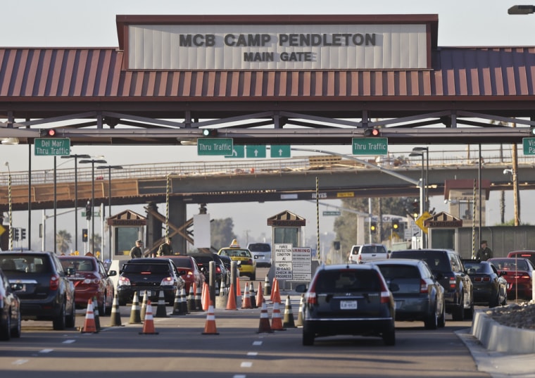 Vehicles file through the main gate of Camp Pendleton, Calif., on Wednesday.
