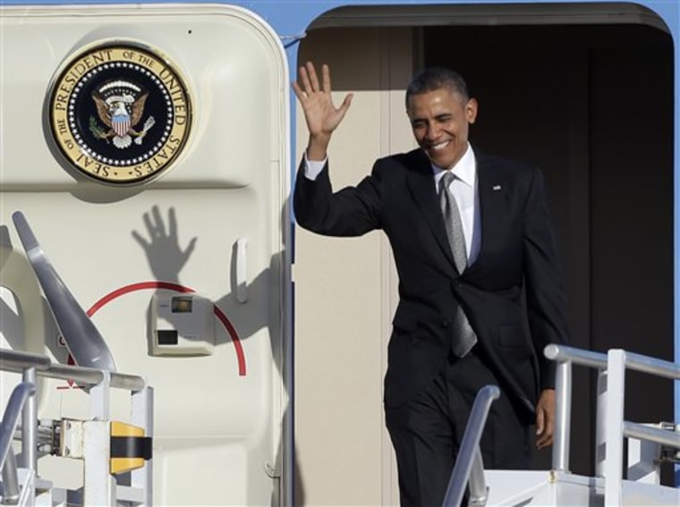 President Barack Obama waves as he arrives at Miami International Airport, Friday, Nov. 8, 2013, in Miami.