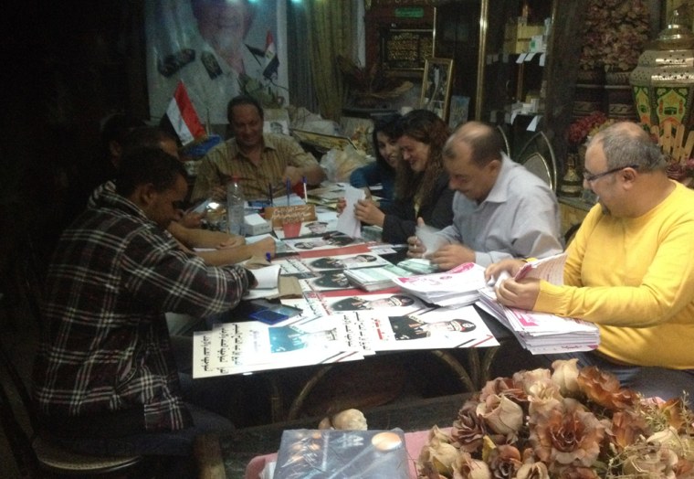 Gen. Ahmed abu el-Azayem, center, and Kaml Gmalek staff stacking petitions in support of Gen. Abdel Fattah el-Sisi.