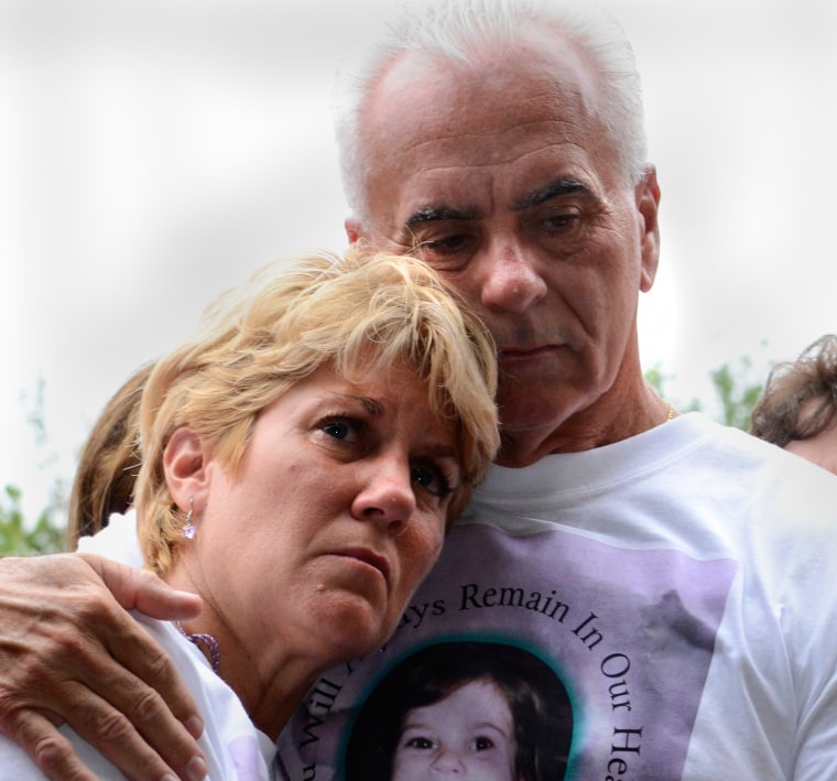 Cindy Anthony is comforted by George Anthony, right, during a memorial ceremony at the site where the body of their granddaughter Caylee Anthony was found on what would have been her sixth birthday in Orlando, on Aug. 9, 2011.