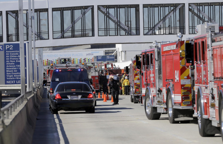 Police stand outside Los Angeles International Airport on Friday, Nov. 1 after shots were fired.