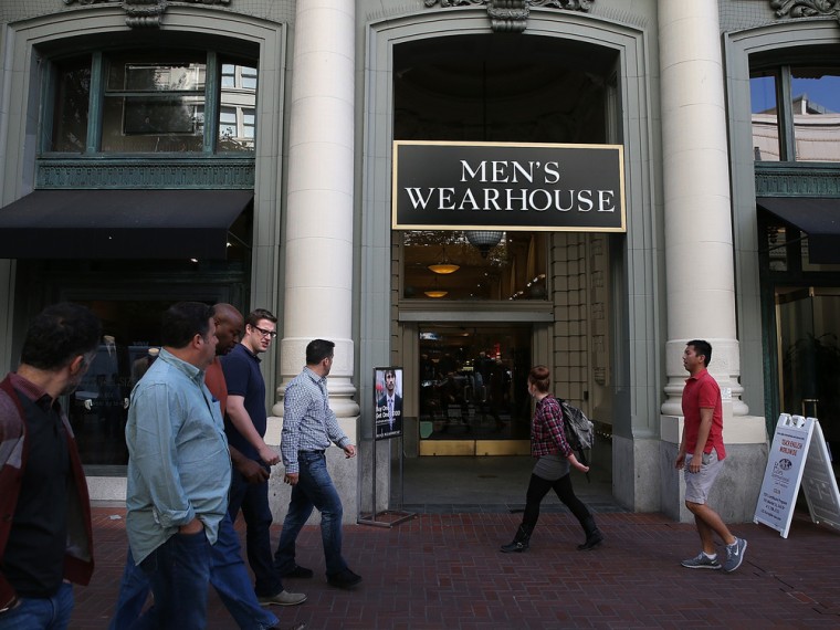 SAN FRANCISCO, CA - OCTOBER 09: Pedestrians walk by a Men's Wearhouse retail store on October 9, 2013 in San Francisco, California. Men's clothing r...