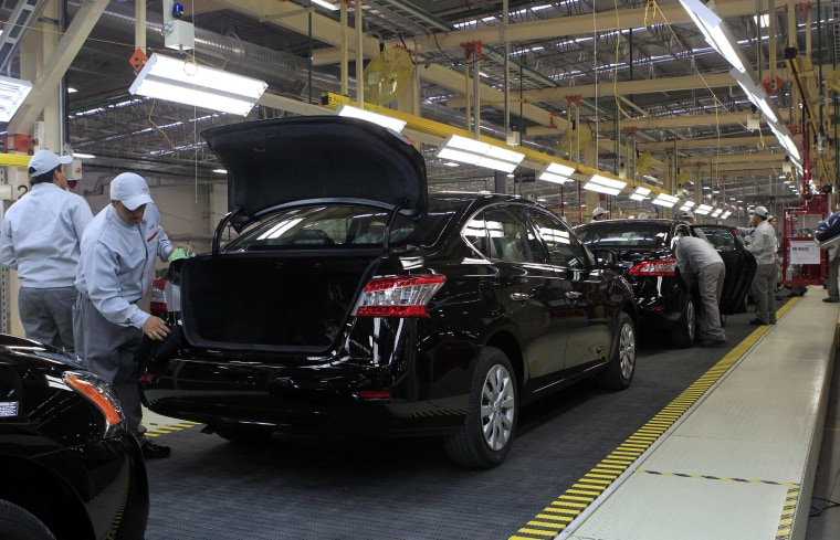 Employees work at a production line before the opening of Nissan's new plant in Aguascalientes, Mexico, on Nov. 12, 2013. Nissan Motor Co. will be producing 1 million cars in Mexico by 2016.