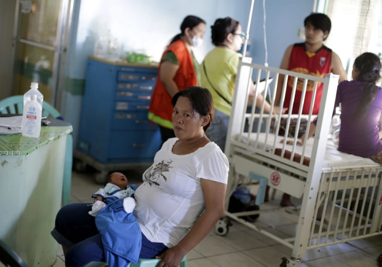 Christine Badanoy, 37, holds her a week-old baby girl, Ujan Marvie, in a medical center in Tacloban, Philippines.