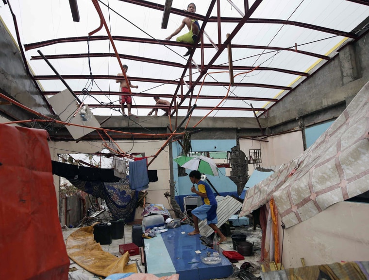 A resident walks inside a damaged home in Tacloban city, Leyte province, central Philippines on Nov. 10, 2013.