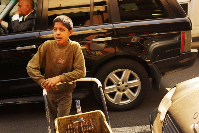 Mohammad, a boy from Daraa, Syria, collects metal scrap to sell.