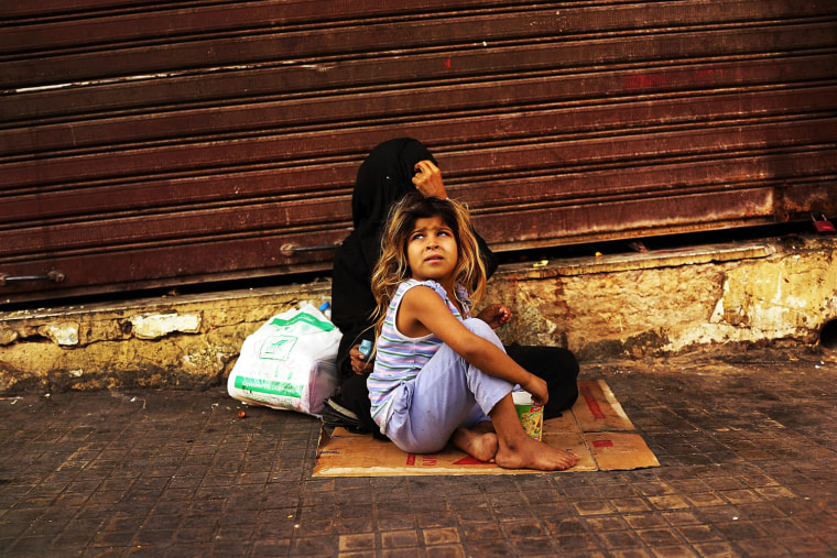 A Syrian woman from Damascus begs with her daughter in a wealthy district of Beirut on Nov. 16.