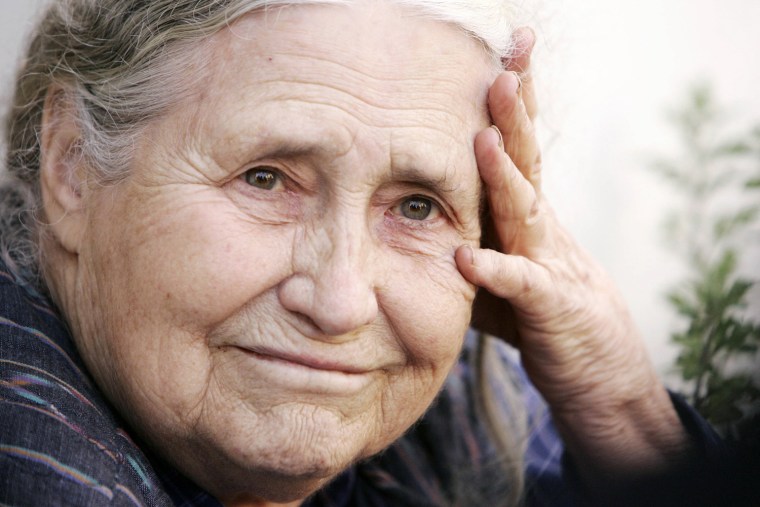 (FILES) In a file picture taken on October 11, 2007 British writer Doris Lessing holds her head in her hands outside her home in north London, as she ...