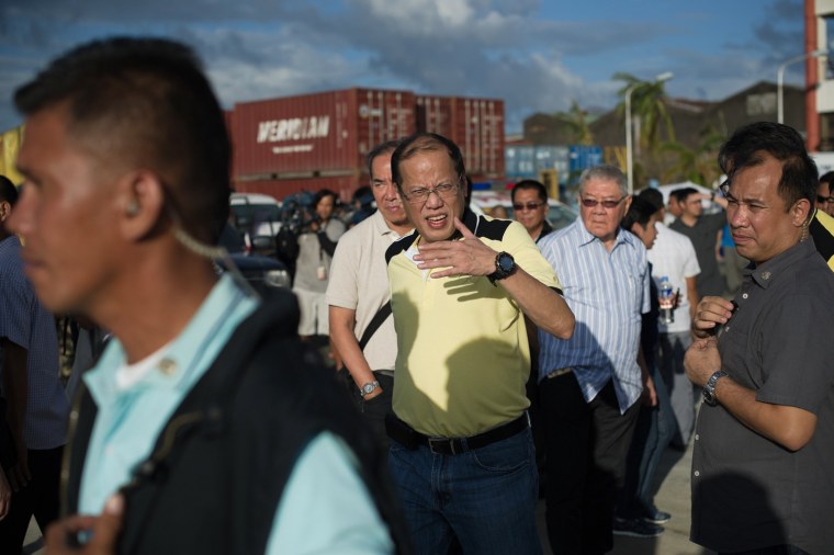 Philippine President Benigno Aquino, center, visits the navy port where some relief supplies arrive by boat in Tacloban, on Nov. 17.